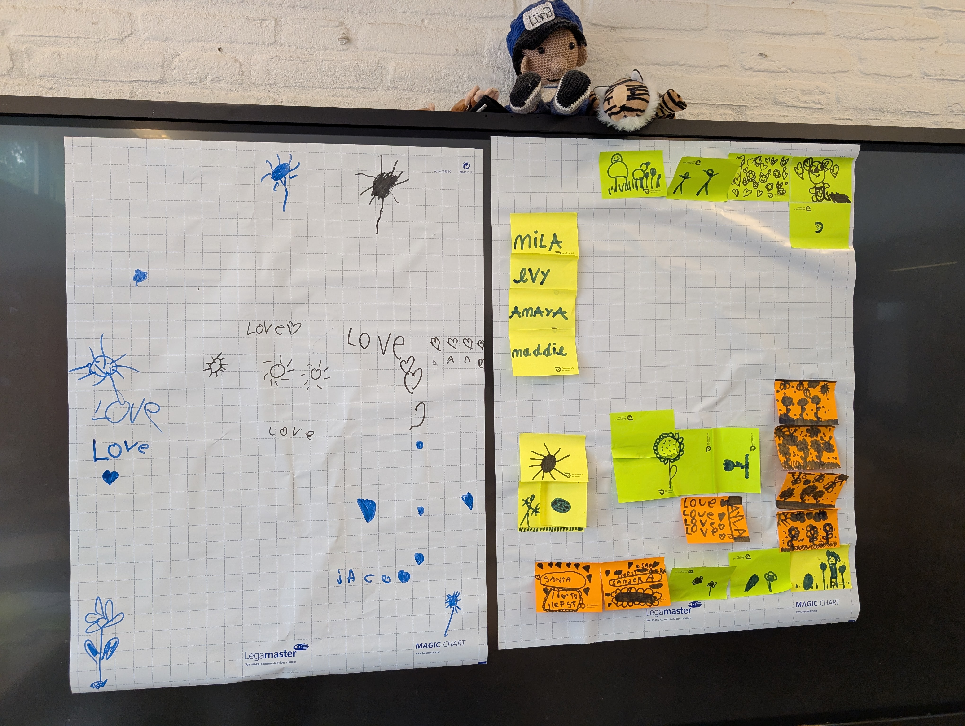 Two drawings. Left: crude hearts and flowers scattered across the paper. Right: Multiple different scenes drawn on stickies and positioned across the paper.